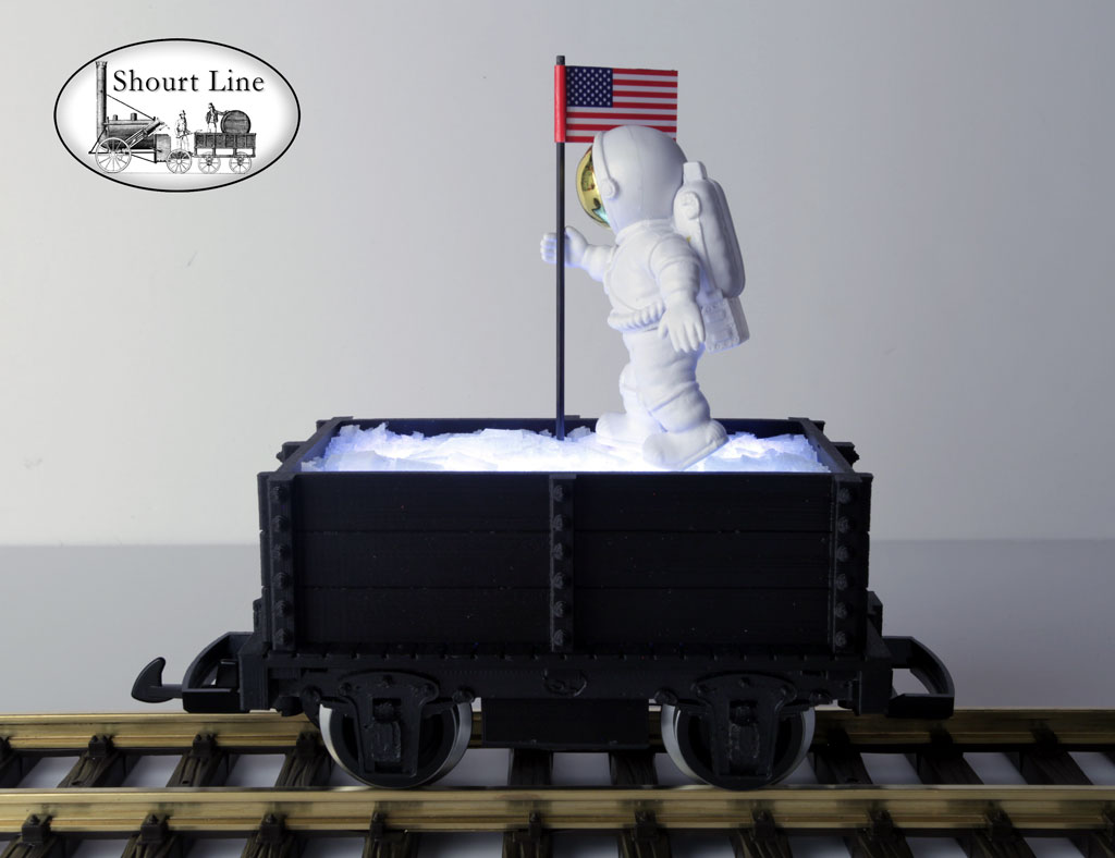 SL 9011139 4th of July Mini-Max Gondola with Ice load lighed by 11 White LEDs, with an Astronaut planting an American Flag on the ice, Track powered, PIKO Metal Wheels LGB Couplers SL WalkWay-Coupler, Assmebled & Wired - Ready to Run NEW - Lighted - On the track left side view